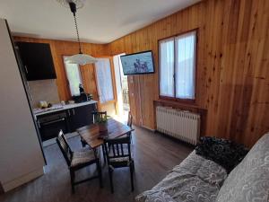 a living room with a table and a dining room at Eva House 2 in Fanano