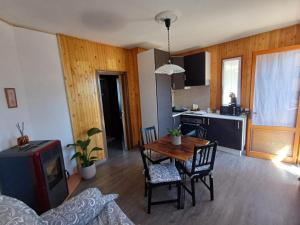 a kitchen and dining room with a table and chairs at Eva House 2 in Fanano