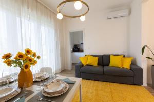 a living room with a couch and a table with yellow pillows at Gradisca Go Home 2 in Gradisca dʼIsonzo