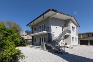 a white house with stairs in front of it at Gradisca Go Home 2 in Gradisca dʼIsonzo