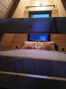 a large bed in a room with a window at Vikendica Bogdanović in Nova Varoš