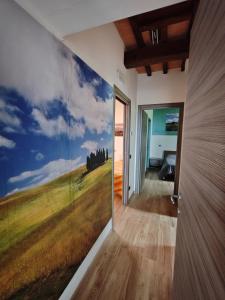a room with a wall with a painting of a field at La Capanna in Radicofani +11 photos