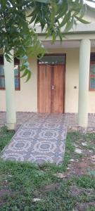 a door to a building with a rug in front of it at Perfect Backpacker Spot in Shimoni