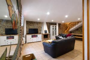 a living room with a couch and a tv at Casa O Castriño in Cambados