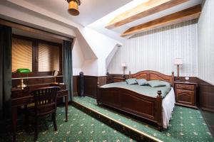 a bedroom with a bed and a desk at U Pana domácího in Zlín