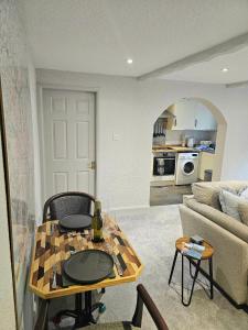 a living room with a table and a couch at Last Yan - Stylish Ambleside Stay in Ambleside