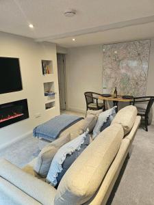 a living room with couches and a map on the wall at Last Yan - Stylish Ambleside Stay in Ambleside
