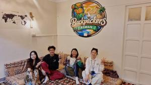 a group of people sitting on a couch in a room at Backpacker Room 2 in Aswan