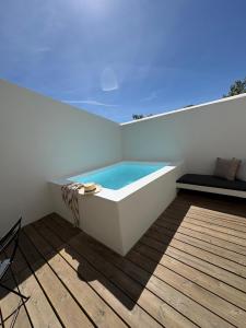 a bath tub sitting on top of a roof at Casa Amanhada Apartamento Zero in Grândola +11 photos