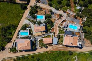 an aerial view of a house with swimming pools at Thalassori Villas in Agios Nikolaos