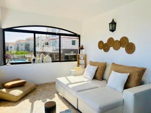 a living room with a white couch and a large window at Flamingo 1 in Arguineguín