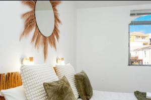 a bedroom with a bed with white pillows and a window at Flamingo 1 in Arguineguín