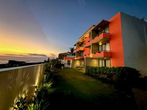 an orange building with a sunset in the background at Linará in Hikkaduwa +11 photos
