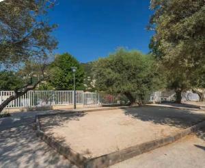 a parking lot with a white fence and trees at Chalet a louer avec piscine in Solliès-Toucas +3 photos
