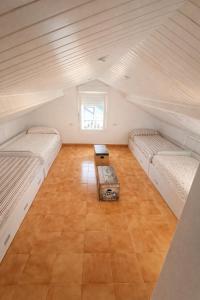 a attic room with two beds and a table at Casa O Castriño in Cambados