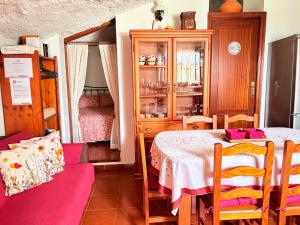 a dining room with a table and a cabinet at Finca Las Polinarias Casa Cueva en Fasnia in Santa Cruz de Tenerife +93 photos