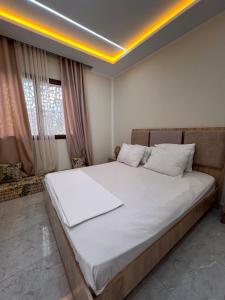 a bedroom with a large bed with white sheets at Dar anas in Fafou +24 photos