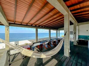 a hammock in a house with a view of the ocean at Linará in Hikkaduwa