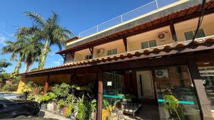a building with a car parked in front of it at Caminho de Itacoatiara in Niterói