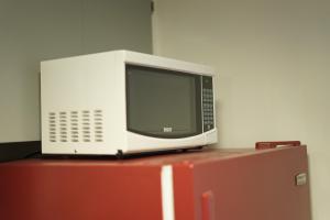 a microwave sitting on top of a refrigerator at Shiraz Suite in Calgary +5 photos