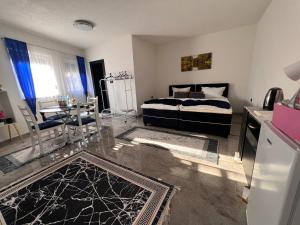 a living room with a bed and a dining room at Apartmani M&DŽ Bihać in Bihać
