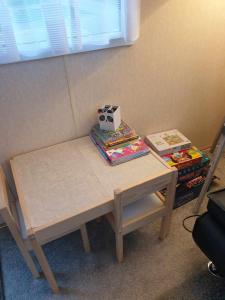 a table with a book and a box on top of it at Holiday Sea Caravan in Withernsea