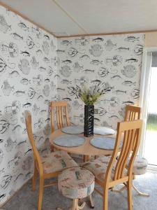 a dining room with a table and two chairs at Holiday Sea Caravan in Withernsea