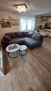 a living room with a couch and two tables at Ferienwohnung Heidebergblick in Lawalde
