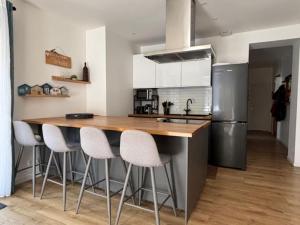 a kitchen with a wooden counter top and a refrigerator at 3 pièces avec terrasse arborée in Arcachon