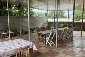 a patio with a table and chairs on a patio at Sheki Ev Guest House in Sheki