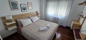 a bedroom with a bed with a box on it at HAIZEA Aire Apartamento 4 in Sopuerta