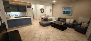 a living room with a couch and a table at Sea & Mountain View Apartment in Chalkida