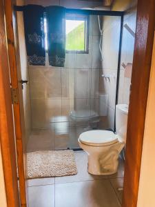 a bathroom with a toilet and a shower at La Maison De Bonneval in São Bento do Sapucaí +24 photos