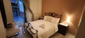 a bedroom with a large bed with white sheets and pillows at Sea & Mountain View Apartment in Chalkida