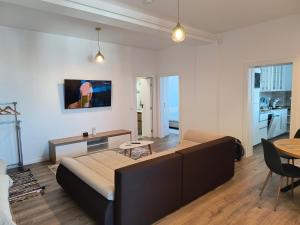 a living room with a large bed and a table at Twin Constantin-Apartment in Suceava