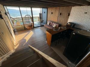 a living room with a view of the ocean at Rukamar Cocholgue in Tomé