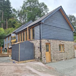 a house being constructed with a garage at Parciau barn in Clyro