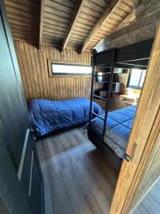 a bedroom with two bunk beds in a house at Rukamar Cocholgue in Tomé +13 photos