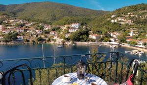 a table on a balcony with a view of a body of water at Costa's House in Kiónion