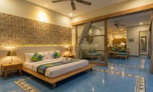 a bedroom with a bed and a living room at Sari Dana Villas in Sanur +22 photos