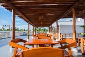 a row of tables and chairs on a patio at Pousada Brisa do Cardeiro in São Miguel do Gostoso