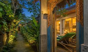 an entrance to a house with chairs and plants at Sari Dana Villas in Sanur