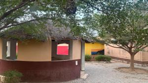 a small building with a straw roof and a tree at SimHan Luxury Hotel & Resort Jengre in Jengre