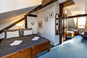 a bedroom with a wooden bed in a room at Penzion Landauer in Český Krumlov