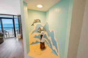 a room with a painting of a shell on the wall at Amazing Oceanfront Accessible Beach Amazing View in Myrtle Beach