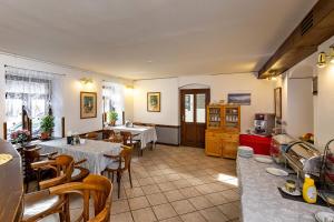 a restaurant with tables and chairs and a kitchen at Penzion Landauer in Český Krumlov