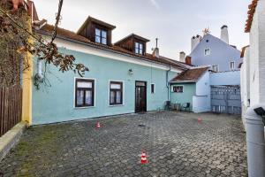 a blue house with orange cones in front of it at Penzion Landauer in Český Krumlov