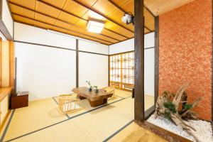 a room with a table and chairs and a large window at Goen in Iwaki