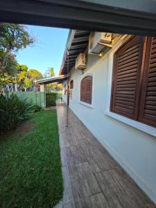 a house with a walkway next to a yard at Hospedagem UniCanto in Campinas