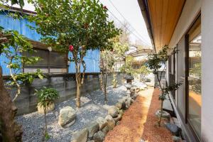 a garden with trees and rocks next to a building at Goen in Iwaki